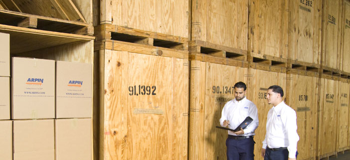 2 men working by storage units