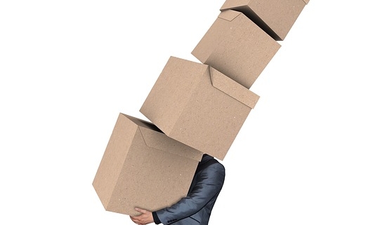 man carrying lots of moving boxes