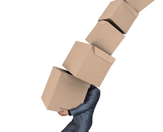 man carrying lots of moving boxes